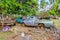 Uvea, Wallis and Futuna. Automotive graveyard, car cemetery yard, abandoned car junkyard under palm trees on a remote island.