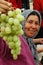 Uyghur woman selling grapes at market