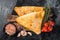 Uzbek and Central Asia samsa, samosa pies. Black background. Top view