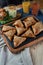 Uzbek dish - mini samosa with sesame seeds on a stone slab. Light effects