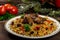 Uzbek national dish pilaf on a dark wooden background with pickles