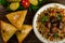 Uzbek national dish of pilaf and samsa on a dark wooden background with pickles