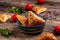 Uzbek national dish samosa. Indian samosas baked pastry with savoury filling, popular Indian snacks, served in bowl with spices on