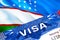 Uzbekistan visa stamp in passport with text VISA. passport traveling abroad concept. Travel to Uzbekistan concept - selective