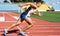 UZHHOROD, UKRAINE - SEPTEMBER 5, 2020: Male teen athlete training on a running track on a stadium UZHHOROD, UKRAINE - SEPTEMBER 5