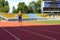 UZHHOROD, UKRAINE - SEPTEMBER 5, 2020: Male teen athlete training on a running track on a stadium UZHHOROD, UKRAINE - SEPTEMBER 5