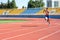 UZHHOROD, UKRAINE - SEPTEMBER 5, 2020: Male teen athlete training on a running track on a stadium UZHHOROD, UKRAINE - SEPTEMBER 5