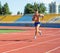 UZHHOROD, UKRAINE - SEPTEMBER 5, 2020: Male teen athlete training on a running track on a stadium UZHHOROD, UKRAINE - SEPTEMBER 5