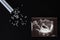 Uzi shot, pills and test tube on a black background, abortion, close-up abortion