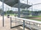 Vacant bleachers near empty baseball field with metal chain link in Dallas, Texas, USA