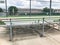 Vacant bleachers near empty baseball field with metal chain link in Dallas, Texas, USA