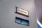 Vacant green sign, vacant symbol on an airplane lavatory door. Raised, brushed metal lavatory sign, recessed plastic vacant sign.