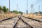 Vacant Rail way switch track with yellow die grass.