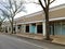 Vacant storefronts face tree lined street