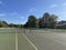 a vacant tennis court in the sunshine