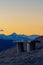 Vacant wooden bench on the hilltop with nice scenic view of Alps in the evening