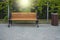 Vacant wooden bench in the park with dustbin