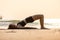 Vacation of Asian woman relaxing in yoga Half bridge pose on sand and beach