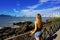 Vacation in Balneario Camboriu, Brazil. Beautiful girl enjoying view of Balneario Camboriu skyline on the Ocean bay. Summer