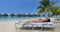Vacation beach travel suntanning young woman on relaxing on beach in bikini