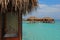 Vacation blue sky turquoise water staying in Overwater Bungalow with shower bath tub bathtub at tropical resort island, Maldives