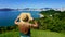 Vacation in Brazil. Panoramic view of traveler girl on viewpoint enjoying Balneario Camboriu skyline, Brazil