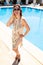 Vacation concept. attractive tourist Caucasian girl in a summer dress with a neckline and sandals stands near the