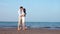 Vacation Couple at beach at sunset romantic holding hands and kissing