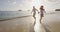 Vacation couple at beach at sunset romantic holding hands running playful