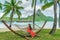 Vacation - Elegant woman relaxing in hammock on Bora Bora travel paradise during summer holidays in tropical Bora Bora