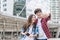 Vacation and friendship concept Selfie smiling asian girl and foreign boy friends with city guide map and backpack in