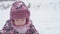 vacation, game, childhood concept - slo-mo authentic happy preschool toddler baby girl in violet hat and mittens blows