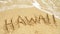 Vacation in Hawaii written in sand