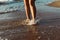 Vacation and holiday concept,Woman legs or foot walking at the beach on sutset time,Close up