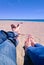 Vacation holidays. Man and woman feet closeup relxing on beach on sunbed enjoying sun on sunny summer day.