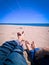 Vacation holidays. Man and woman feet closeup relxing on beach on sunbed enjoying sun on sunny summer day.