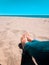 Vacation holidays. Woman feet closeup relxing on beach on sunbed enjoying sun on sunny summer day.