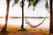 Vacation Relaxation hammock hanging from coconut trees on beach