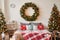 Vacation Rentals. Interior apartment. Christmas bedroom. Bed against background of Christmas tree and wreath. New Year's Eve