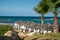 Vacation resorts on Cyprus near Paprhos with green grass, beach umbrellas, beds, beaches and palm trees, travel destination in EU