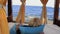 Vacation. sea. blonde girl lies on a sofa under a canopy with sun loungers and looks at the blue sea on a sunny day. Shooting from