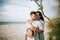 Vacation at sea of â€‹â€‹young people, families. Young couple hugging on the beach