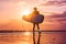 Vacation Silhouette Of A Surfer Carrying His Surf Board Home At