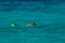 Vacation tourist, young person, snorkeling in paradise clear water. Snorkeler in crystalline waters . Turquoise sea background