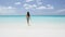 Vacation travel bikini woman walking on beach