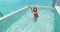 Vacation travel pool fun. Woman having fun in pool laughing excited and happy enjoying luxury travel lifestyle. Girl