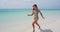 Vacation travel woman happy cheerful joyful laughing running having fun on beach