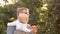 Vacation in the village. Grandfather and grandson walk in the apple orchard. Harvest, setting sun, autumn walk