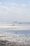 vacation at Wadden Sea.Silhouettes of people on the beach.Frisian Islands of Germany. walking on watt dunes.Walks along