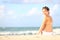 Vacation woman sitting on beach